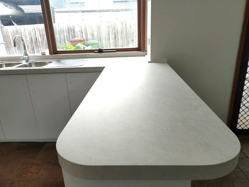 Benchtop wrapped in white stone finish