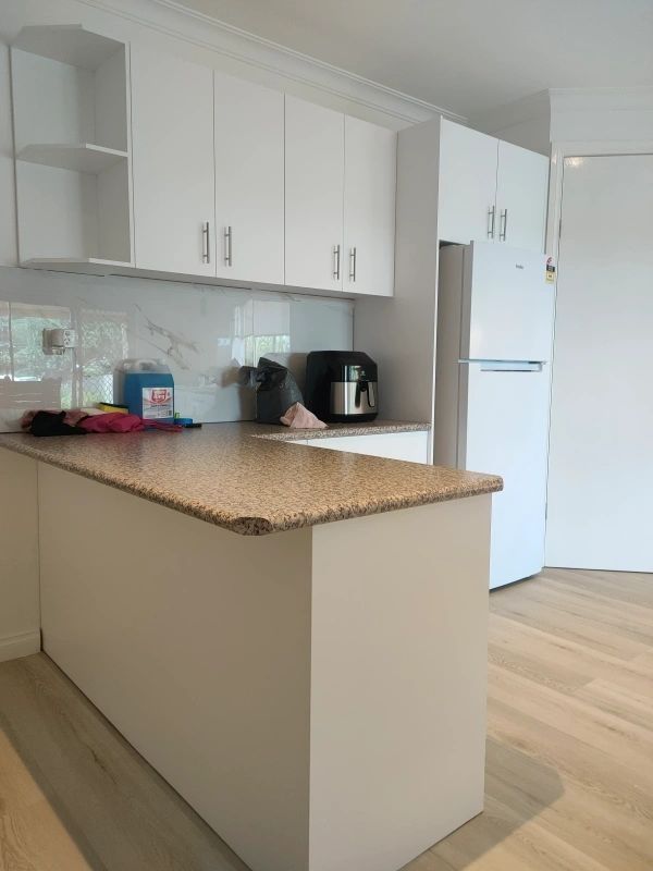White cabinetry and granite bench